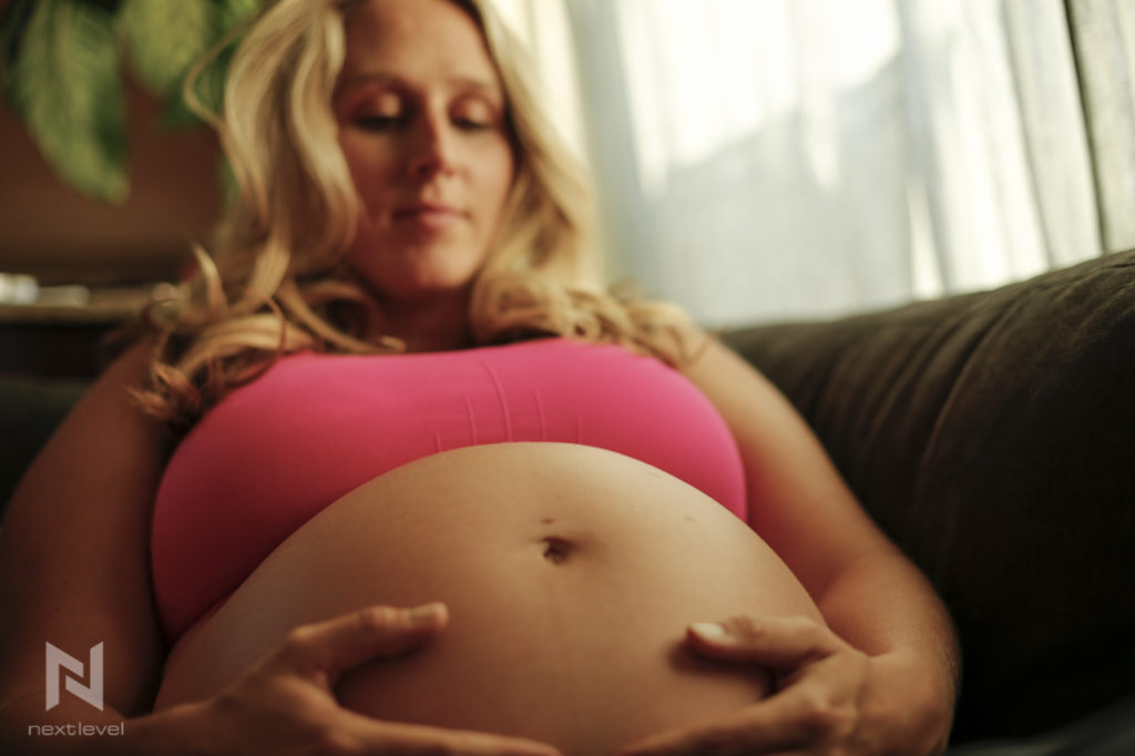 pregnant woman looking at belly